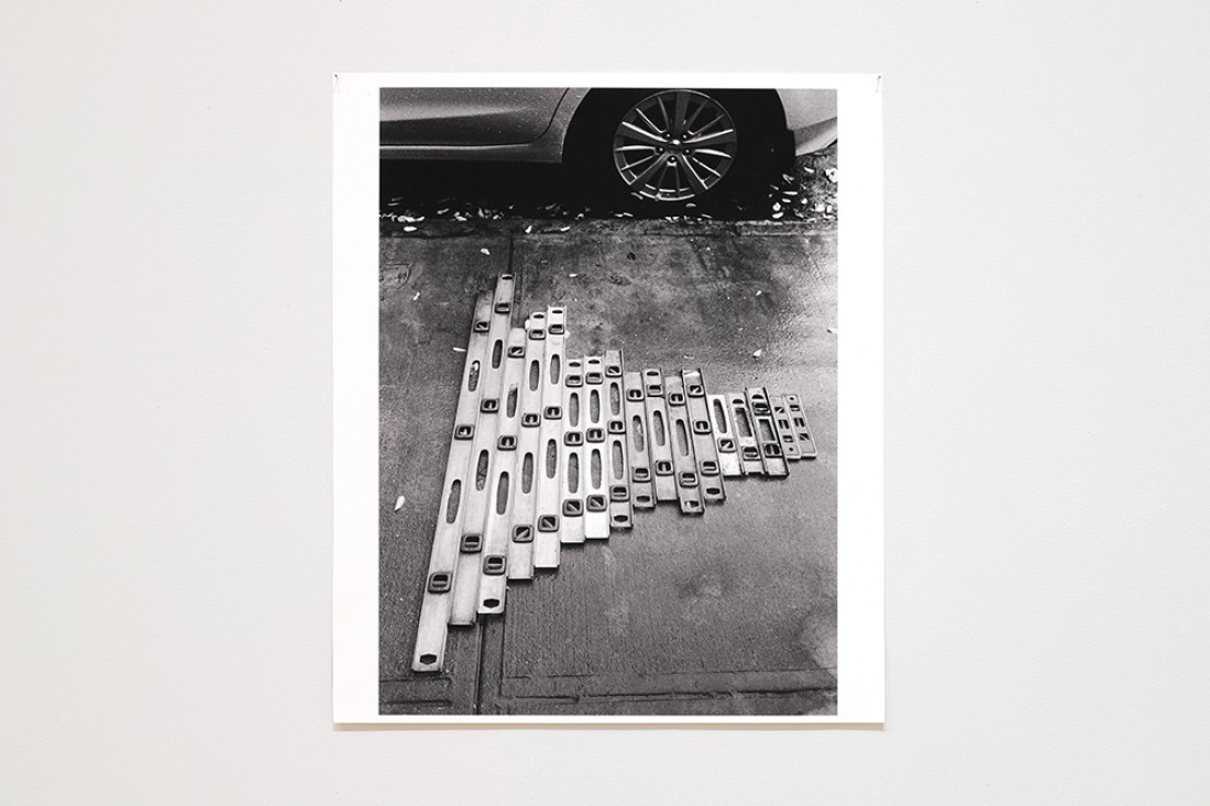 black and white photo of levels on sidewalk 