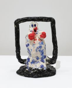 ceramic figurative sculpture with black frame