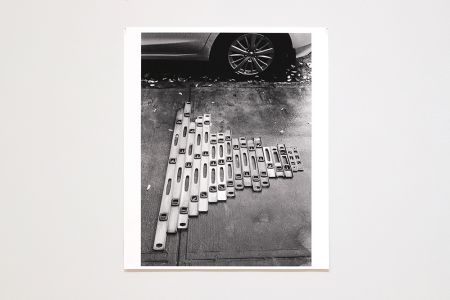 black and white photo of levels on sidewalk 